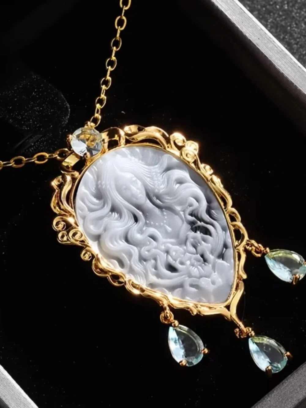 Gold Cameo Pendant Necklace with Gray Cameo and Light Blue Gem Drops